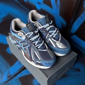 Deep blue performance-style sneakers for men with cushioned sole and premium box packaging.
